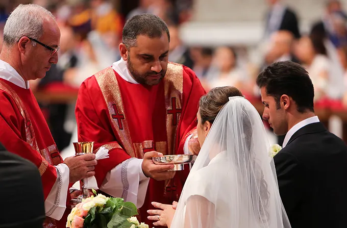  A couple newly married by Pope Francis receives communion in St. Peter's Basilica on Sept. 14, 2014. ?w=200&h=150