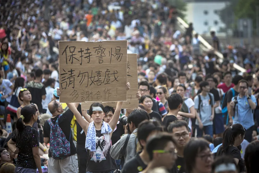 A demonstrator holds a sign as thousands pack the streets of Hong Kong in protest Oct. 1, 2014. ?w=200&h=150