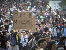 A demonstrator holds a sign as thousands pack the streets of Hong Kong in protest Oct. 1, 2014. 