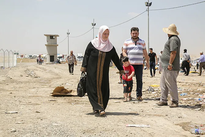 A family at the Khazair checkpoint after fleeing from Mosul Iraq on June 11 2014 Credit R Nuri UNHCR ACNUR via Flickr CC BY NC SA 20 CNA 7 23 14