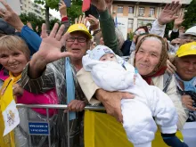 The grandmother and grandchild who feature on Pope Francis' new prayer card greet the pope in Romania June 1, 2019. 