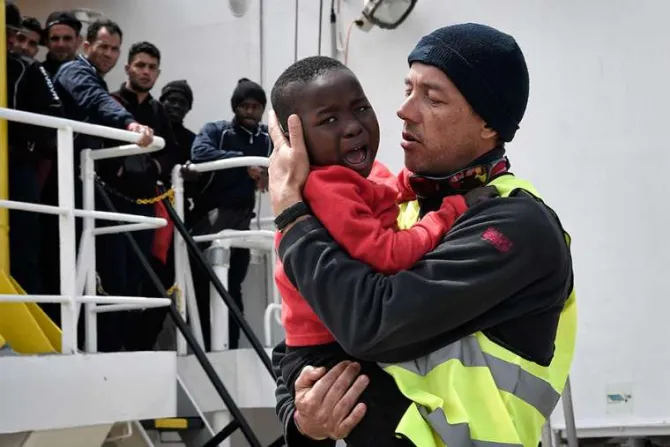 A helper from Doctors Without Borders holds a Nigerian child as he and his mother disembark from the MV Aquarius upon its arrival at the Sicilian port of Messina on May 14 2018 Credit LOUISA GOULIAMAKI AFP Getty Images
