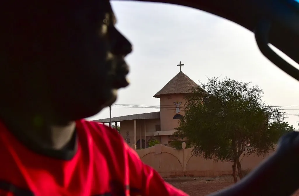 A man drives past a church in Ouahigouya, Burkina Faso. ?w=200&h=150