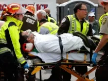 A man is loaded into an ambulance after he was injured by one of two bombs exploded during the 117th Boston Marathon near Copley Square on April 15, 2013. 