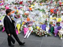 A man places flowers as a mark of respect for the victims of Martin Place siege on December 16, 2014 in Sydney, Australia. 