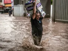 A man wades in a flooded street in Culiacan, Sinaloa State, Mexico, Sept. 20, 2018. 