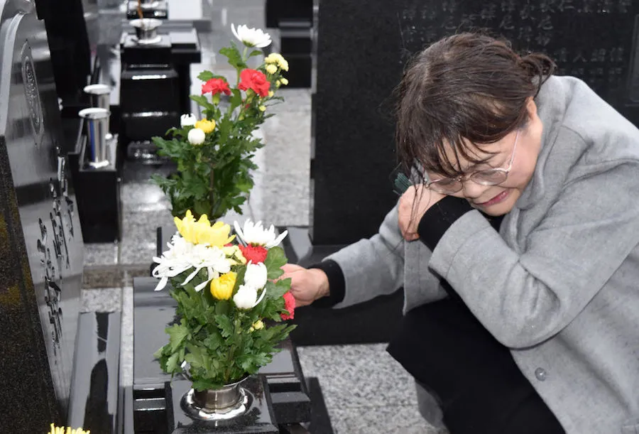 A mourner at a cemetery on the eighth anniversary of the March 11, 2011 tsunami in Japan. ?w=200&h=150