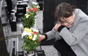 A mourner at a cemetery on the eighth anniversary of the March 11, 2011 tsunami in Japan.   Jiji Press / AFP / Getty Images.