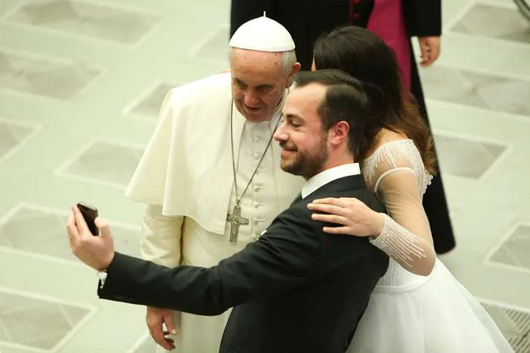 A newly married couple snaps a selfie with Pope Francis at the Wednesday general audience on Feb. 4, 2015. ?w=200&h=150