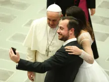 A newly married couple snaps a selfie with Pope Francis at the Wednesday general audience on Feb. 4, 2015. 