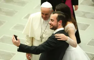 A newly married couple snaps a selfie with Pope Francis at the Wednesday general audience on Feb. 4, 2015.   Daniel Ibanez/CNA 