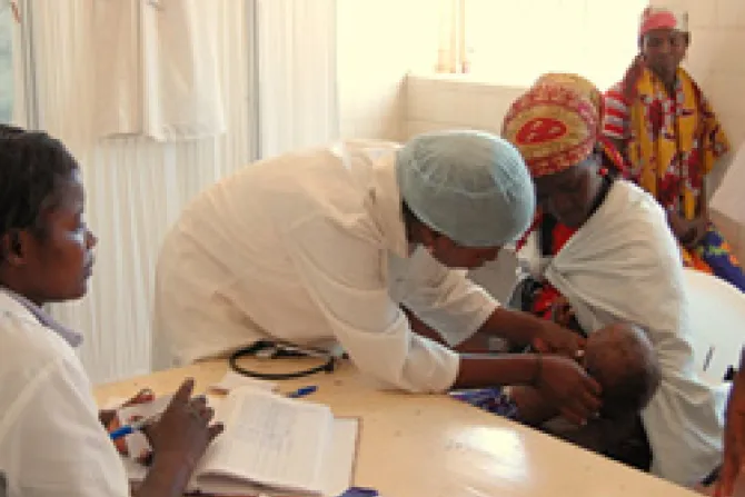 A nurse in a local clinic in Huambo Province Angola checks a patient and her baby Credit USAID Alison Bird CNA US Catholic News 10 4 11