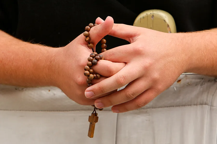 A pilgrim prays the rosary in St. Peter's Square before the General Audience, Oct. 19, 2014. ?w=200&h=150