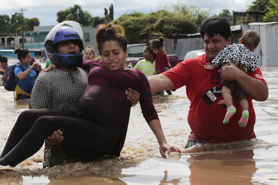 A pregnant woman is carried out of an area flooded by Hurricane Eta in Planeta, Honduras, Nov. 5, 2020. ?w=200&h=150