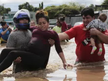 A pregnant woman is carried out of an area flooded by Hurricane Eta in Planeta, Honduras, Nov. 5, 2020. 