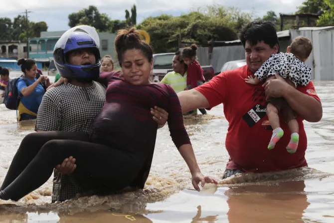 A pregnant woman is carried out of an area flooded by Hurricane Eta in Planeta Honduras Nov 5 2020 Credit Alex Gakos  Shutterstock 
