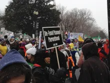 A prolife supporter holds a Defund Planned Parenthood sign at the March for Life, Jan. 25, 2012. 