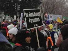 A pro-life supporter holds a Defund Planned Parenthood sign at the March for Life, Jan. 25, 2012. 