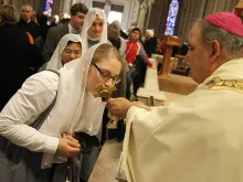 A religious sister kisses the relic of Bl. Miriam Teresa Demjanovich during her beatification ceremony Oct. 4, 2014. 