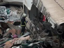 A rescue worker sifts through the crash scene outside of Santiago de Compostela, Spain on July 25, 2013. Pablo Blazquez Dominguez/Getty Images News.