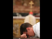 A seminarian from the North American College lays prostrate on the ground as part of his Diaconate Ordination in St. Peter's Basilica on Oct. 2, 2014. 