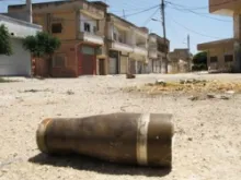 A shell lays in the middle of the street in Homs, Syria, a remnant of the heavy attack leveled on the city on June 11, 2012. 