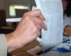 A person casts their ballot. ?w=200&h=150