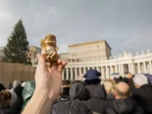 A statue of the Baby Jesus from a Nativity scene is held up for the blessing at St Peter's Square on “Bambinelli” Sunday, Dec. 15, 2013.