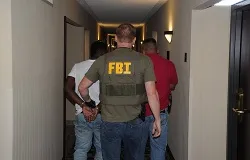 A suspect is taken into custody by FBI agents in Jackson, Mississippi during Operation Cross Country VIII in June 2014. ?w=200&h=150