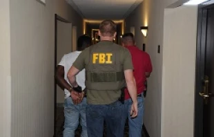 A suspect is taken into custody by FBI agents in Jackson, Mississippi during Operation Cross Country VIII in June 2014.   Federal Bureau of Investigation.