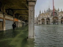 A tourist walks through the water in Piazza San Marco Oct. 29, 2018 in Venice, Italy. 