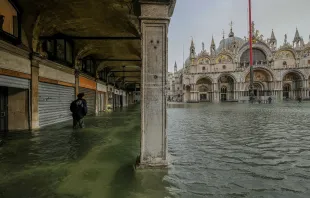 A tourist walks through the water in Piazza San Marco Oct. 29, 2018 in Venice, Italy.   Stefano Mazolla/Awakening/Getty Images.