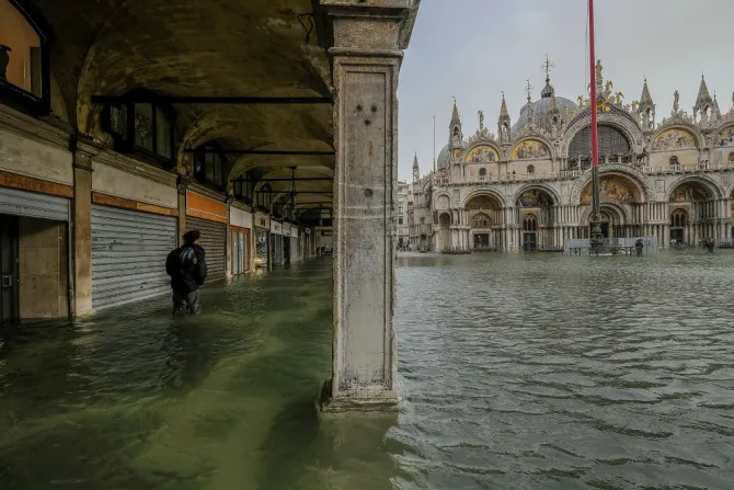 A tourist walks through the water in Piazza San Marco Oct 29 2018 in Venice Italy Credit Stefano Mazolla Awakening Getty Images CNAjpg