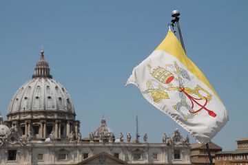 A view of St Peters Basilica 1 and Vatican City flag from the roof of a nearby building on June 5 2015 Credit Bohumil Petrik CNA 6 5 15