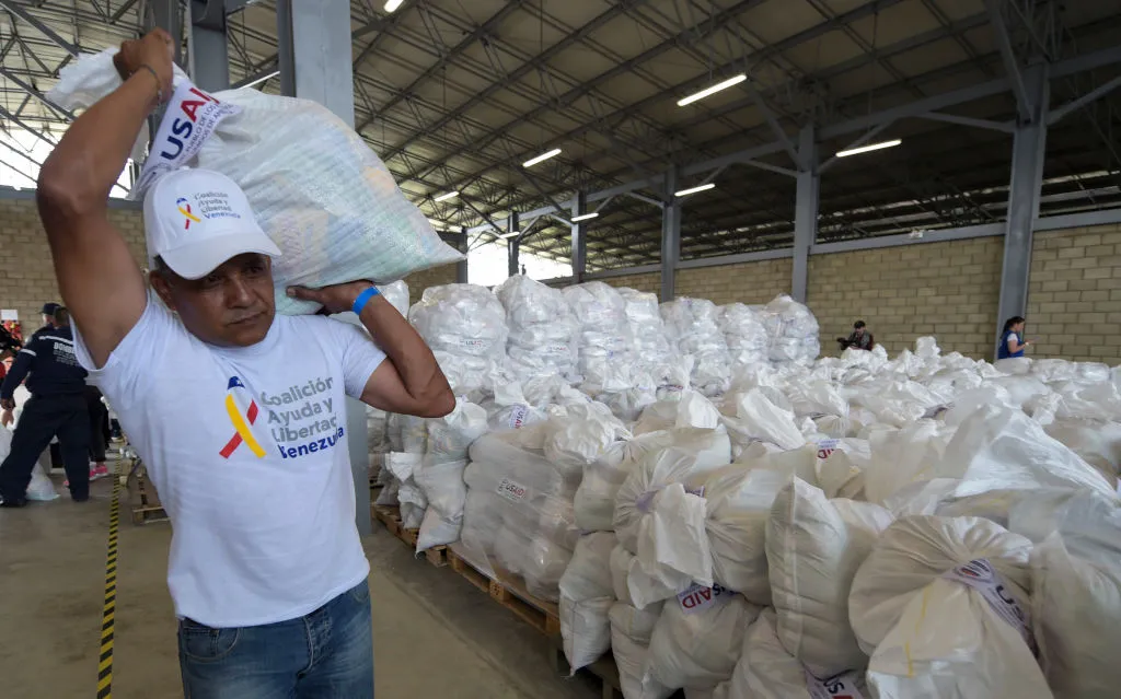 A volunteer carries a bag with US humanitarian aid goods in Cucuta, Colombia, on the border with Tachira, Venezuela, Feb. 8, 2019. ?w=200&h=150