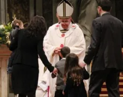 A young family brings the offertory to Pope Francis at the Christmas Vigil Mass on December 24. ?w=200&h=150