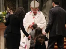A young family brings the offertory to Pope Francis at the Christmas Vigil Mass on December 24. 