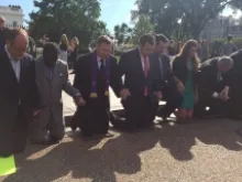 Supporters of Pastor Saeed Abedini kneel to pray at a prayer vigil and rally in Washington, D.C. 