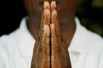 African man in prayer Credit Salim October via wwwshutterstockcom CNA