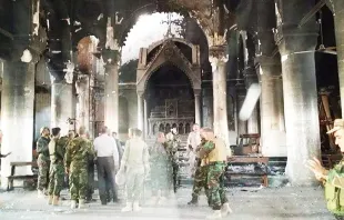 Soldiers survey damaged inflicted by Islamic State forces on Al Tamera Syriac Catholic church in the city of Bakhdida, Iraq, near Mosul. Photo courtesy of Fr. Roni Momika. 