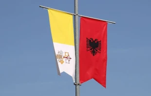 Papal and Albanian banners line Albania's streets.