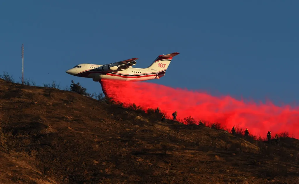 An air tanker drops fire retardant over power lines while helping to fight the Hillside Fire in San Bernardino, California, Oct. 31, 2019. ?w=200&h=150