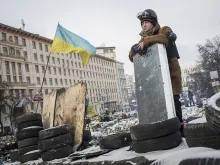 An anti-government protestor stands on top of a barricade on Grushevskogo Street Jan. 29, 2014 in Kiev, Ukraine. 
