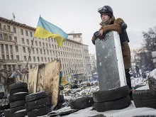 An anti-government protestor stands on top of a barricade on Grushevskogo Street Jan. 29, 2014 in Kiev, Ukraine. 