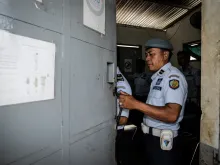 An officer closes the gate of Kerobokan prison in Indonesia, where Myuran Sukuraman and Andrew Chan are jailed, Feb. 10, 2015. 