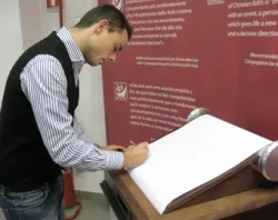 Andrea Manfredonia writes on the Faith Scroll at the Vatican's Pilgrim Office. ?w=200&h=150