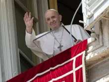 Pope Francis waves from his window overlooking St. Peter’s Square during an Angelus address. 