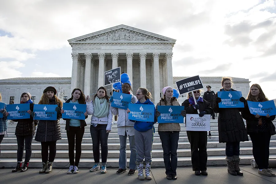 Anti-abortion advocates stand outside of the Supreme Court, March 2, 2016 in Washington, DC during abortion arguments. ?w=200&h=150