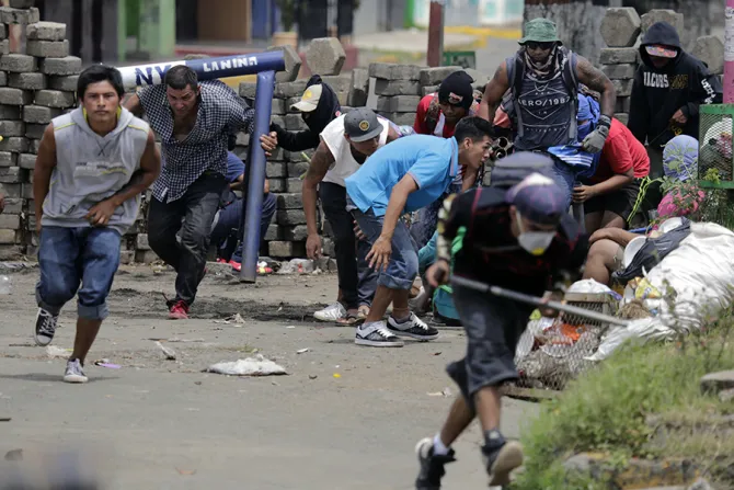 Anti government demonstrators take cover behind a barricade during clashes with riot police and members of the Sandinista youth in Masaya some 35 km from Managua on June 19 2018 Credit INTI OCON AFP Getty Images cna