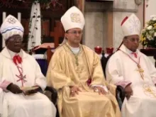 Archbishop Joseph Spiteri (c) says Mass with Cardinal Malcolm Ranjith (r), Dec. 2, 2013. 